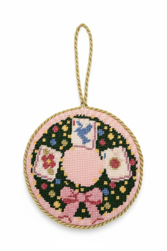  "Handcrafted needlepoint mahjong wreath ornament with vibrant tile motifs in red, pink, green, and gold"
